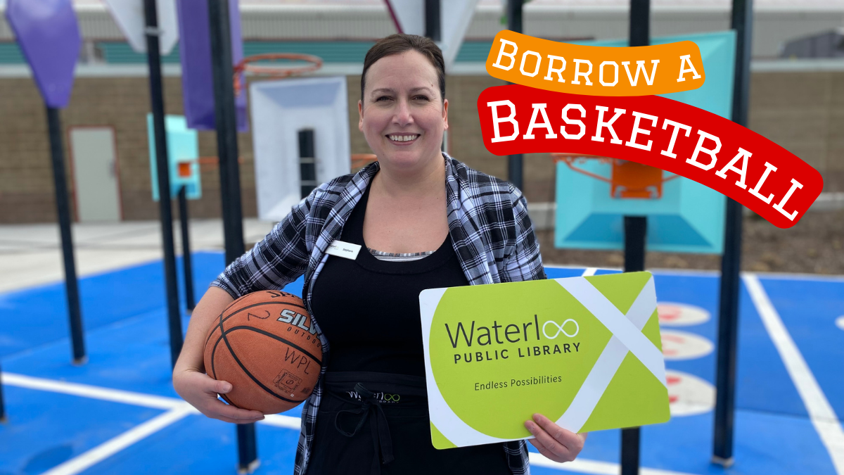 Image of a WPL staff member holding a basketball and a giant library card